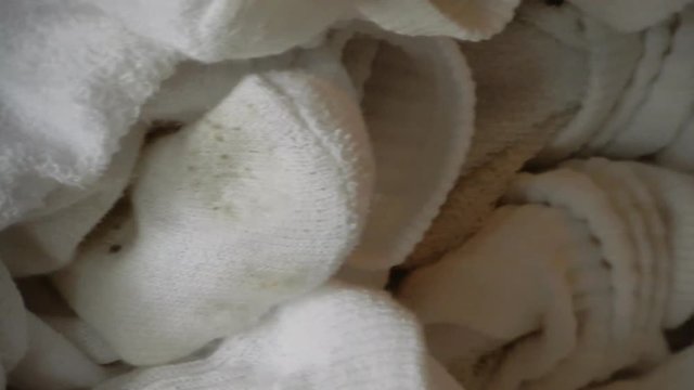 4 K Pan Of Dirty White Socks Closeup Left To Right