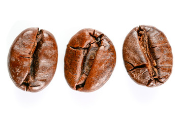 Coffee beans. Three roasted coffee beans maccro view, close up, isolated on white background.