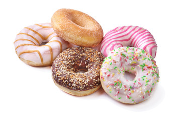 assorted delicious homemade doughnuts in the glaze, colorful sprinkles and nuts isolated on white background.