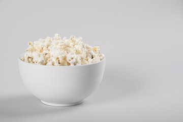 Popcorn in a bowl, isolated on white
