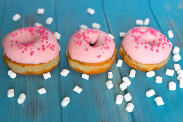 Photo of donuts on a blue wooden background. Sweets. Photos of donuts for blog, magazine and recipes