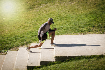Closeup portrait of a Fitness girl doing pushups on a park during a blue and sunny day