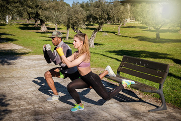 Closeup portrait of a Fitness girl doing pushups on a park during a blue and sunny day