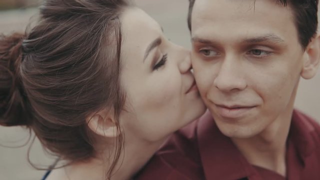 Attractive couple kiss each other. Sensual close up shot in slow motion