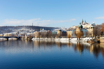 Snowy Prague Lesser Town with Prague Castle above River Vltava, Czech republic