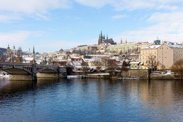 Fototapeta premium Snowy Prague Lesser Town with Prague Castle above River Vltava, Czech republic