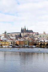 Obraz premium Snowy Prague Lesser Town with Prague Castle and Charles Bridge, Czech republic
