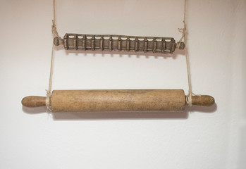 wooden rolling pins to make pasta hanging on the wall
