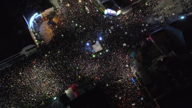 Orbit Maneuver Aerial Footage View Of People Crowd Around Yogyakarta Monument Or TUGU JOGJA From Above During New Year Celebration