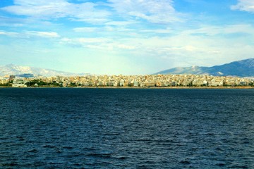 Panoramic view of Piraeus over the sea with mountains in background. Athens, Attica, Greece