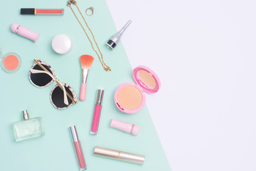 Beauty and cosmetic products flat lay image on split color background.