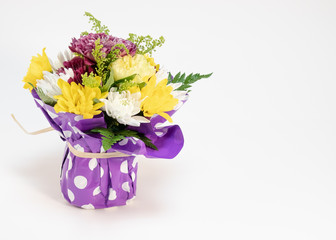 Bouquet of Mother's Day Flowers in a purple polka dot wrap with open space