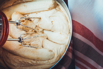 Banana Bread Batter Being Mixed In A Stainless Steel Bowl On A Wooden Table