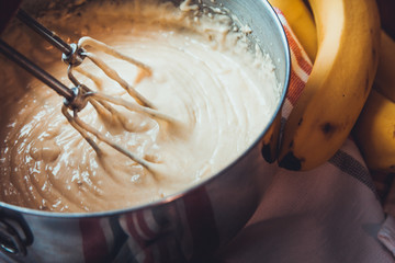 Banana Bread Batter Being Mixed In A Stainless Steel Bowl On A Wooden Table