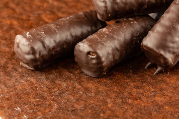 Chocolate bars on brown paper background close-up