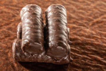 Chocolate bars on brown paper background close-up