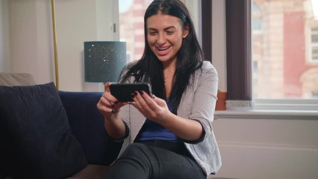 Attractive Young Woman Watches Her Team Score On Smartphone and Wins Online Bet, In Slow Motion