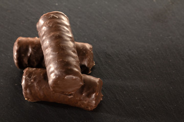 Chocolate bars on a black shale tray
