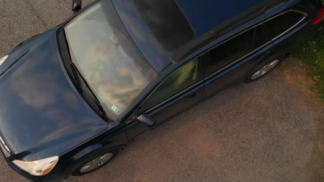Subaru in Driveway in Summer with Clouds in Reflection AERIAL