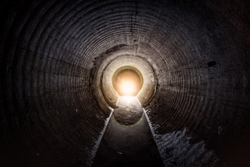 Flooded round underground drainage sewer tunnel with dirty sewage water - obrazy, fototapety, plakaty