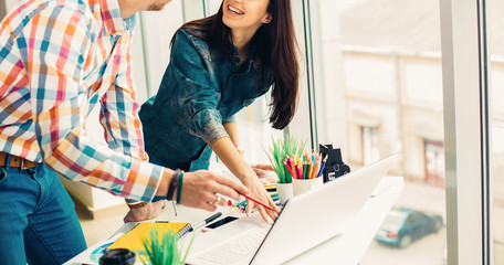 Cute creative designers working on new project in modern office