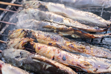Catfish grilled on a charcoal stove.