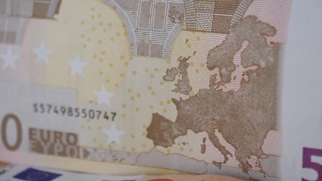 Macro close-up rack focus over a 50 Euro bank note, currency.