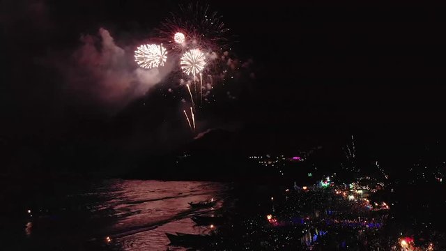 Fireworks at New Year Eves night above dance festival on tropical island beach
