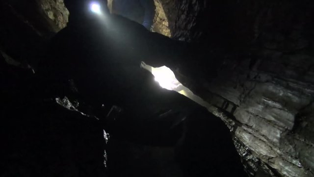 Cavers move through challenging passage