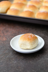 Closeup of Homemade Dinner Roll on White Plate on Black Background