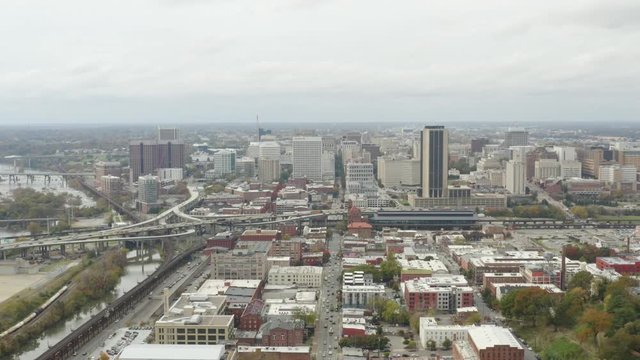 Flying over downtown Richmond towards the city skyline. You can see the traffic pass below of the smaller neighborhoods.