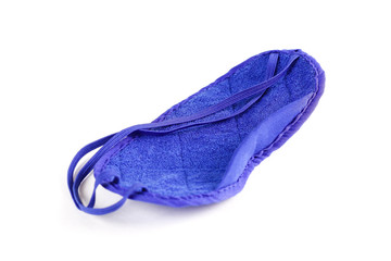 Blue mask on eyes. Sleep mask. Close up. Isolated on white background