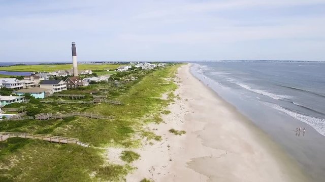 Oak Island lighthouse on a bright sunny day with empty beach