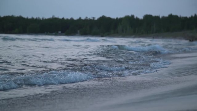 Slow motion footage of waves crashing on the beach.