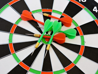 Dart arrow hitting in the target center of dartboard. Success hitting target aim goal achievement...