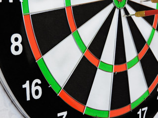 Dart arrow hitting in the target center of dartboard. Success hitting target aim goal achievement...