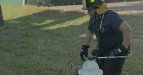 Firefighter opens hydrant during training