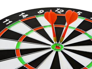 Dart arrow hitting in the target center of dartboard. Success hitting target aim goal achievement concept background.Darts and dart board.Close up shot of the dart arrow.Marketing concept. Dartboard.