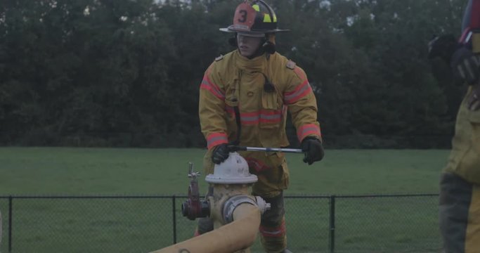 Firefighter opens fire hydrant