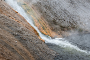 Hot water falls running down the colourful rocks in Yellowstone National Park