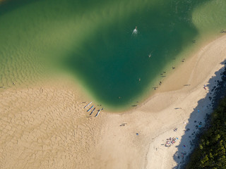 People on the edge of a sand bank in Australia