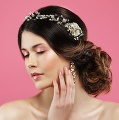 Wedding earrings on a female hand, she takes the earrings, wear earrings.