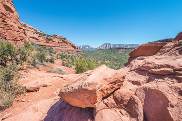 Landscape scenery of Sedona, Arizona with a boulder in the foreground.