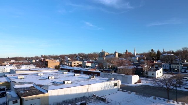 Aerial view with a horizontal pan of the north-western side of Lemont, a small urban town in Illinois USA. It's a bright sunny, blue skies type of winter afternoon.