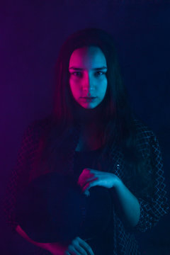  woman in colorful High Fashion model bright neon blue and purple lights posing in studio, beautiful girl
