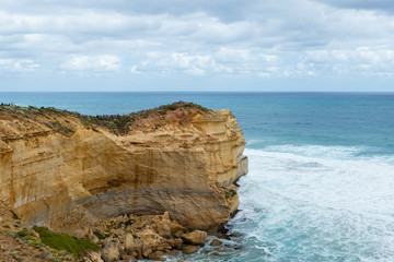 Fototapeta na wymiar Rock cliff towards the vast ocean. Great Ocean Road, VIC, Australia.