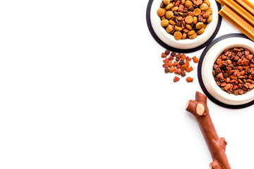 Fototapeta premium Animal food in bowl on white background top view copy space