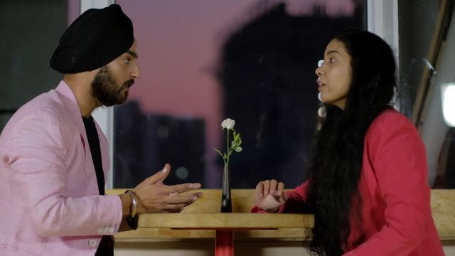 Lovers argue and have a fight where the girl rejects and returns his gift slams him and throws flowers at him as he apologies, she runs away as he tries to calm her on valentine's day on 14th February