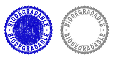 Grunge BIODEGRADABLE stamp seals isolated on a white background. Rosette seals with grunge texture in blue and gray colors. Vector rubber imprint of BIODEGRADABLE text inside round rosette.