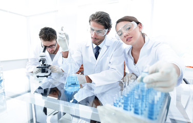 Scientist holding test tube or some equipment of science